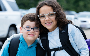  two children smiling with glasses